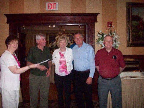 Team LetterKenny (Brian McCaul, Nora Martin, Charlie McElwee and Bill McHugh) receiving their winnings from Treasurer Nora Campbell.