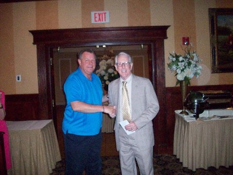 Bob Robinson presenting John During with his team's winnings.